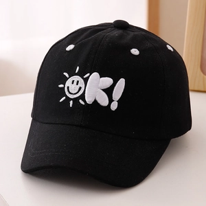 Close-up of black kids baseball cap with white Sun OK emoji embroidery detail