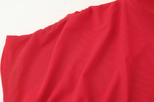 Close-up of premium red honeycomb mesh fabric showing detailed texture and vibrant color