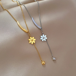 Minimalist Y-shaped flower pendant necklaces in gold and silver steel on beige silk