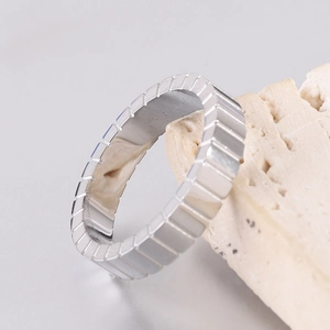 Macro shot of 4mm silver stainless steel ring featuring textured vertical grooves