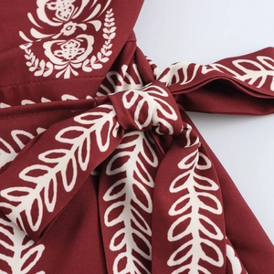 Bohemian tube dress featuring ethnic leaf print and waist tie knot in dark red