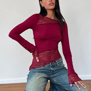 Detail of burgundy long sleeve top with intricate lace stitching and slim fit design
