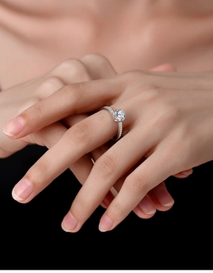 Macro detail of Moissanite ring with six-claw setting and small side accent diamonds