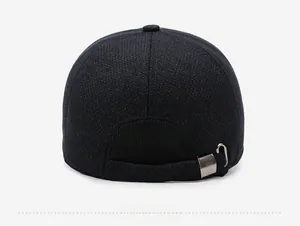 Detail of navy blue thermal baseball cap featuring a silver metal adjustable strap buckle