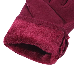 Close-up of thick fleece lining and knit texture on winter thermal gloves in wine red