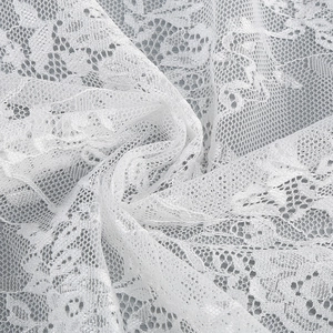 Gros plan sur l'élégante dentelle blanche avec détails de broderies florales ajourées