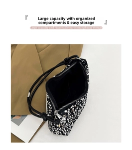 Detail view of the spacious inner compartments and fabric lining of this sequin shoulder bag