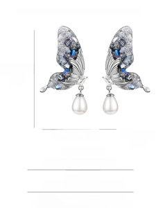 Detail view of crystal butterfly pearl earrings with dimensions 4.5cm by 2.2cm on white background