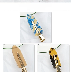 Three acetate hair clips featuring marble blue, light brown, and tortoiseshell patterns