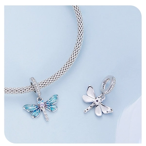 Macro view of blue enamel dragonfly charm with S925 hallmark and sparkling zircon stones