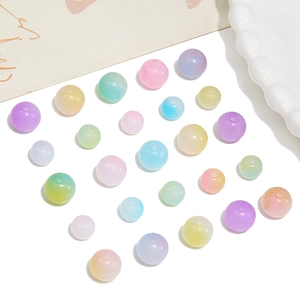 Colorful translucent acrylic jelly beads for DIY jewelry making on white surface