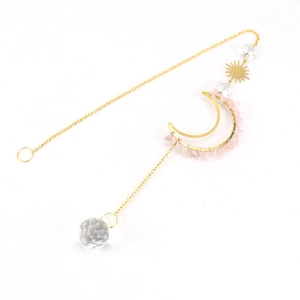 Detail of moon suncatcher with gold metal frame, pink stones and faceted crystal ball