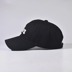 Detailed view of the side profile on this cotton baseball cap with white TALES embroidery