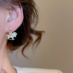 Detail of Trojan horse earrings with gold plating, pearls and tiny rhinestones