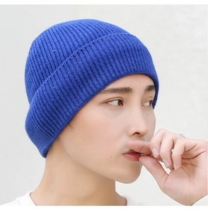 Close-up of royal blue ribbed knit beanie showing high-quality textile texture and finish