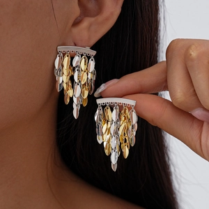 Metallic leaf tassel drop earrings in gold and silver finish on professional model