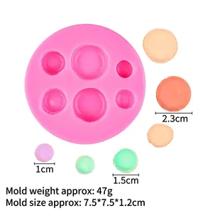 Detailed view of pink silicone macaron mold with 6 cavities and dimensions marked