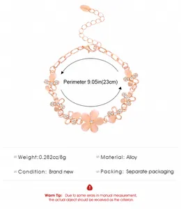 Detail view of gold flower bracelet with pink cat eye stone petals and size chart