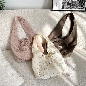 Detailed texture of floral corduroy tote bags in pink, beige and brown colors