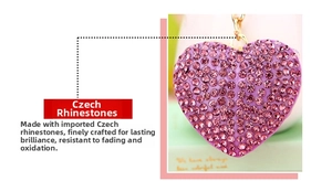 Detail of purple heart keychain with hand-set Czech rhinestones and gold ring