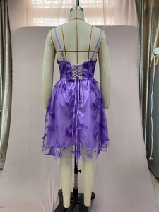 Detailed view of purple tulle dress with 3D butterfly embroidery and lace-up back design