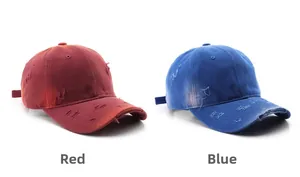 Detail of distressed vintage baseball caps in red and blue with washed worn-out texture