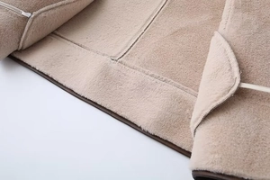 Macro detail of soft beige lamb wool lining on a stylish fashion winter coat