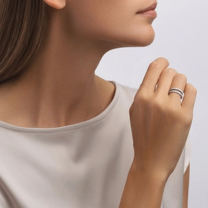 Detail of elegant double-row moissanite ring in 925 silver on a female finger