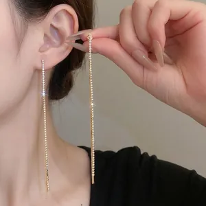Sparkling silver needle tassel earrings with gold plating and paved rhinestones
