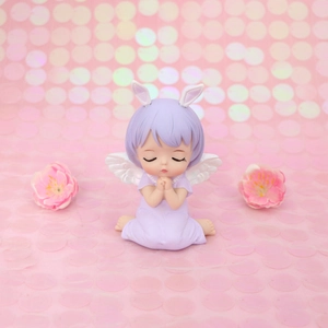 Macro shot of cute purple angel figurine with rabbit ears for cake decoration