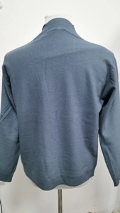 Detail view of the back of a dark grey-blue men's knit cardigan with ribbed cuffs