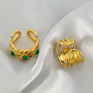 Vintage 18k gold plated stainless steel rings with green malachite on silk background
