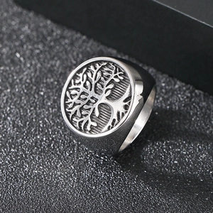 Detailed close-up of vintage tree of life engraving on a silver stainless steel signet ring
