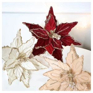 Detail of velvet poinsettia flowers with glitter edges in burgundy and champagne