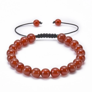 Detail of red agate bead bracelet with adjustable black braided rope on white background