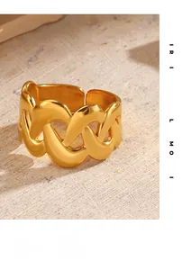 Detailed close-up of an 18K gold-plated braided crossover ring on stone texture