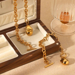 Detailed macro view of a gold-plated chunky chain with OT toggle clasp and unique pendant