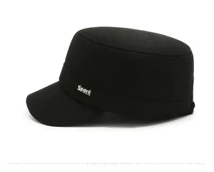 Detail of black wool flat top military cap with a silver Sport metal logo on the side