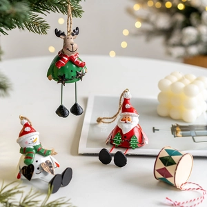 Festive Christmas resin ornaments featuring Santa, Snowman, and Reindeer on a lit tree