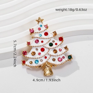 Macro view of a white enamel Christmas tree brooch with colorful rhinestones and size info
