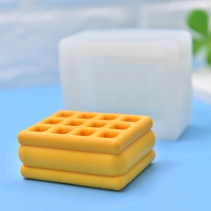 Stack of yellow waffle-shaped silicone molds with clear grid texture and tiered design