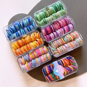 Set of 7 boxes with 60 vibrant fluorescent elastic hair bands for kids, seamless design