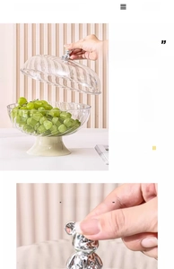 Detail of transparent striped fruit tray with silver bear handle and drain base