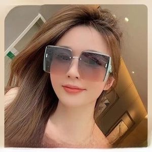 Front view of model wearing rimless butterfly sunglasses with purple gradient lenses