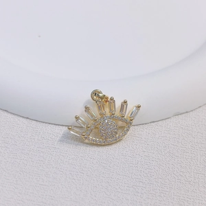 Golden evil eye pendant with micro-paved cubic zirconia and baguette-cut eyelashes decor