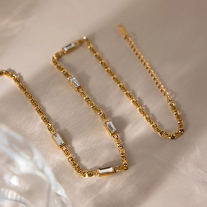 Close-up of 18K gold plated S-link chain featuring five rectangular zircon stones