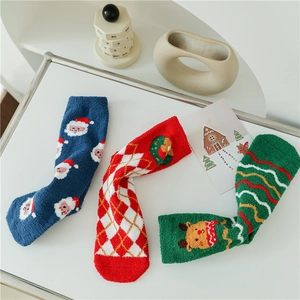 Three festive Christmas coral fleece socks in blue, red, and green with holiday patterns