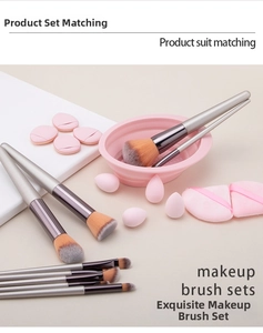 Detailed 33-piece makeup tool set with silver brushes, pink sponges, and cleaning bowl