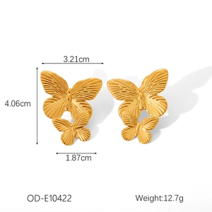 Detailed view of golden butterfly earrings with precise size and weight specifications