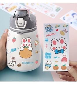 Detail of cute rabbit stickers on white cartoon water bottle with pop-up lid mechanism